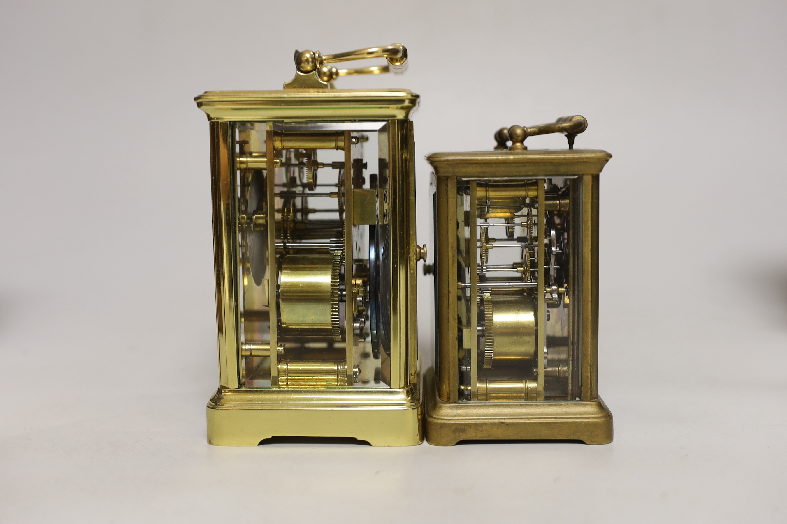 Two cased brass carriage cased clocks, one a repeating carriage clock, tallest 15cm high